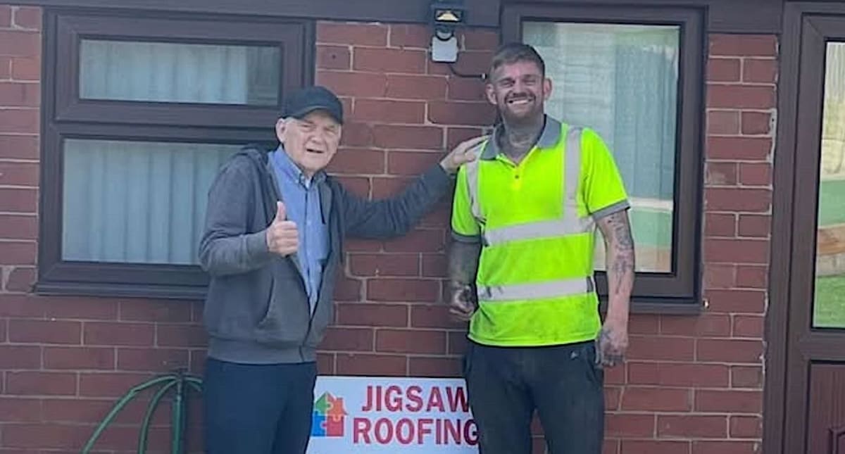 Roofer working shirtless on elderly widower's damaged roof in Oldham, England