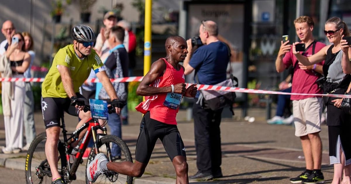Marathon runner Sabastian Sawe crossing finish line in London celebrating historic sub-2-hour time