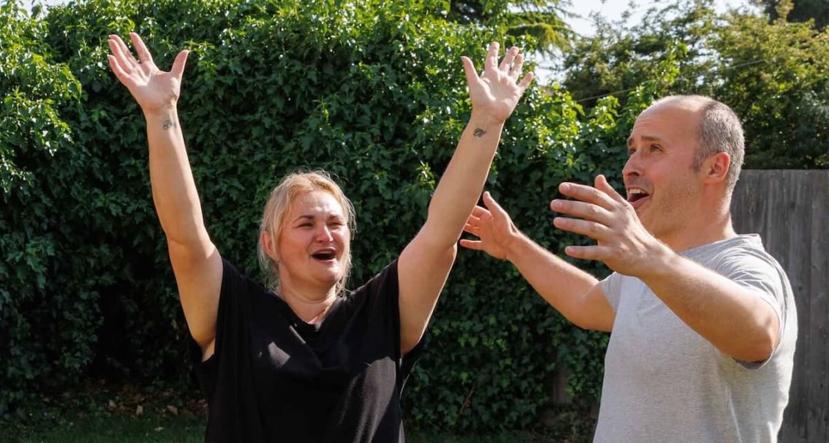 Honorata Jamrozik and her husband celebrating their lottery win with smiles and champagne glasses