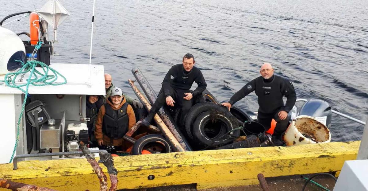 Sean Bath and team pulling abandoned fishing nets and trash from Canadian ocean harbor