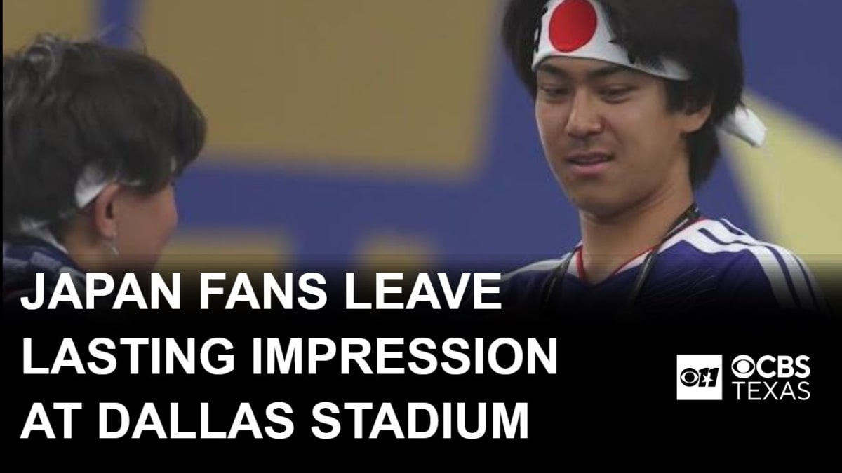 Japanese soccer fans collecting trash in stadium seats after World Cup match