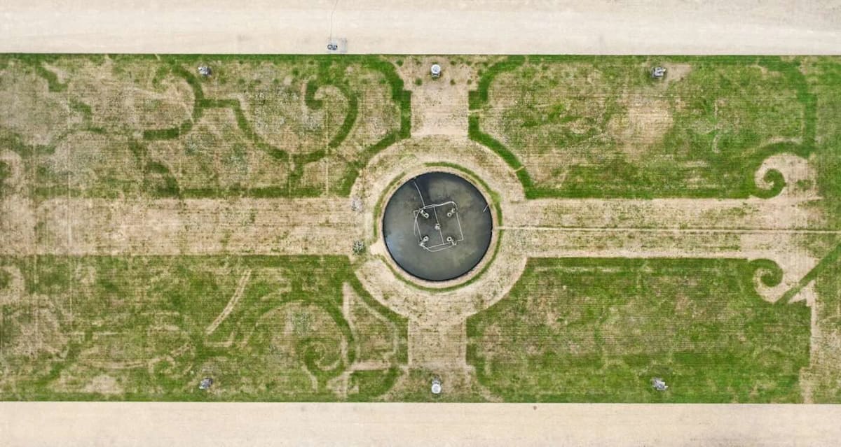 Aerial view showing brown patterns of 17th century garden design visible in parched lawn at Chatsworth House
