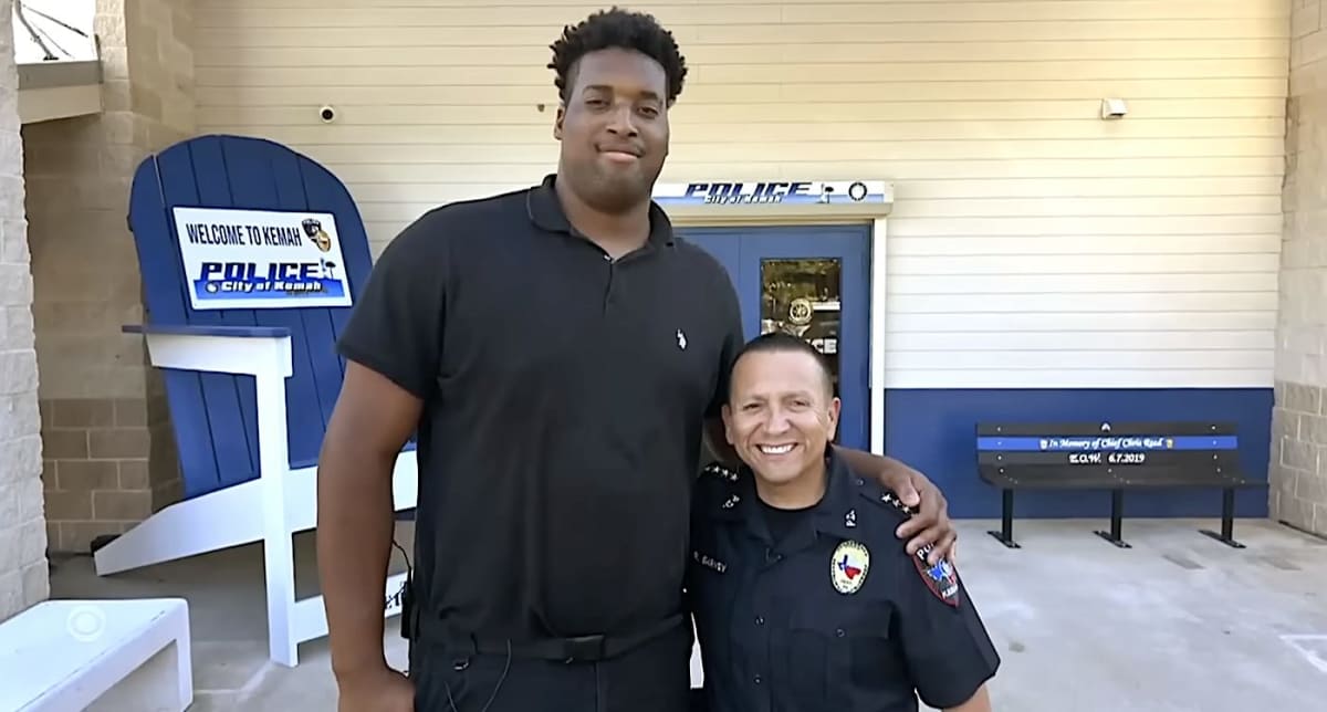Jordan Wilmore in Kemah Police Department uniform standing tall at seven feet three inches