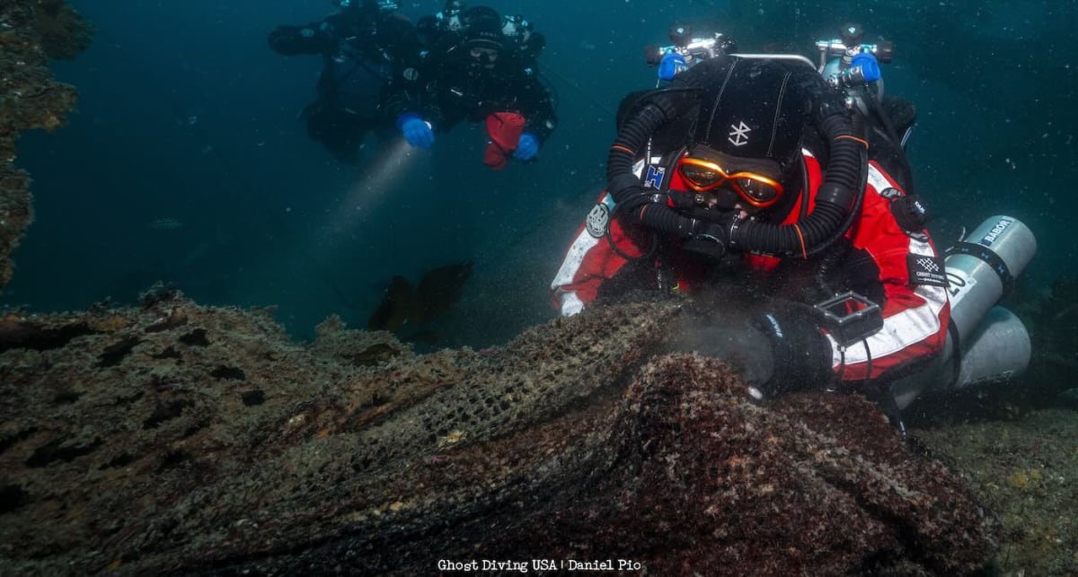Divers recovering tangled abandoned fishing nets from ocean floor near Catalina Island wreck site