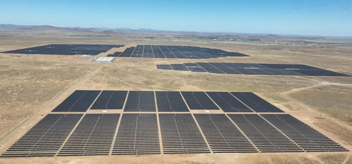 Aerial view of vast solar panel arrays in South Africa's Northern Cape desert landscape