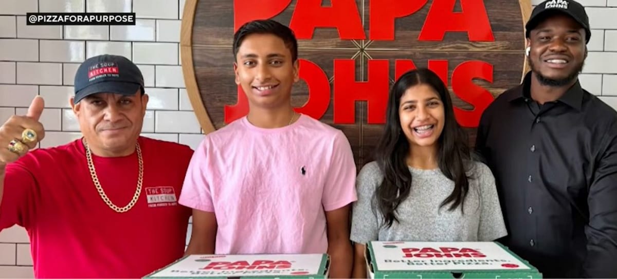 Two South Florida teens smiling with pizza boxes for their charity app Pizza for a Purpose