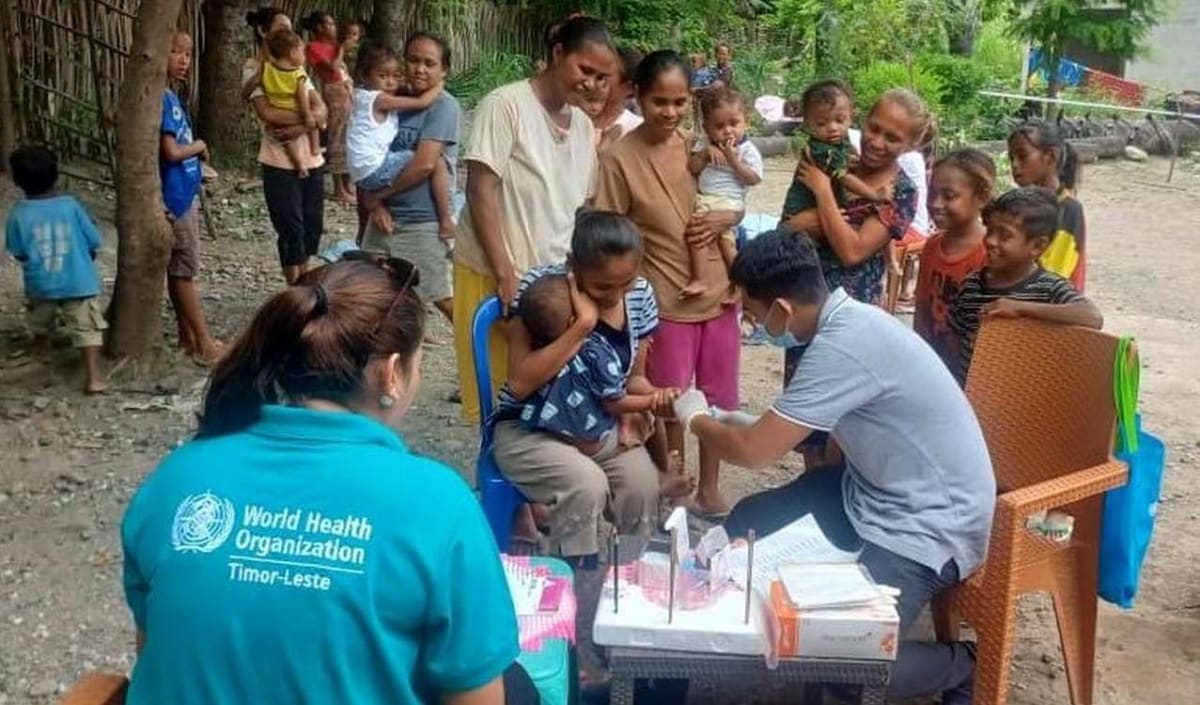 Health worker collecting samples from child during trachoma surveillance survey in Timor-Leste