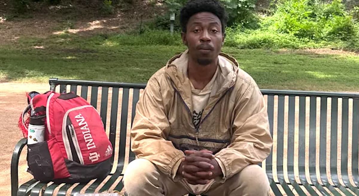 Sampson James wearing red Indiana University athletic backpack that led to his rescue from homelessness