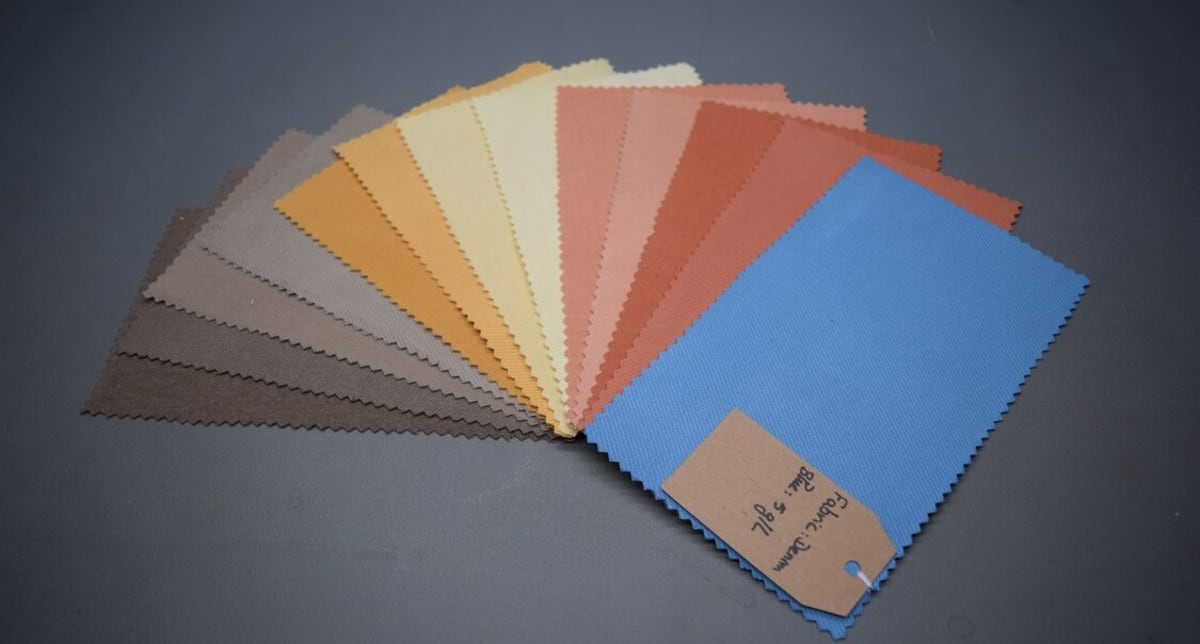 Colorful textile fabrics being dyed using EverDye's electromagnetic sustainable dyeing technology process