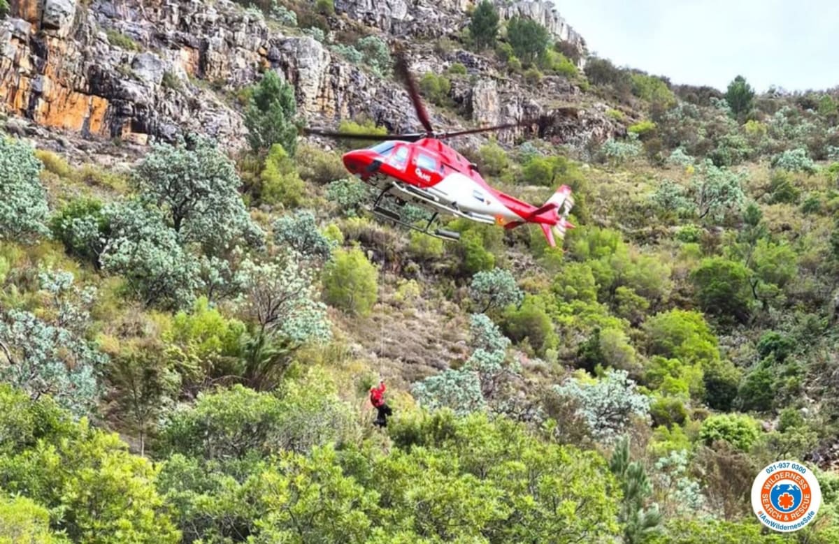 ** Wilderness Search and Rescue team members working along swollen river during nighttime rescue operation