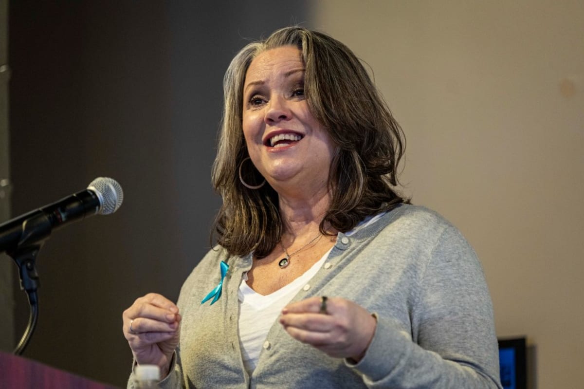 ** Speaker addressing large audience of community advocates at Sexual Assault Victim Advocate Center summit in Johnstown