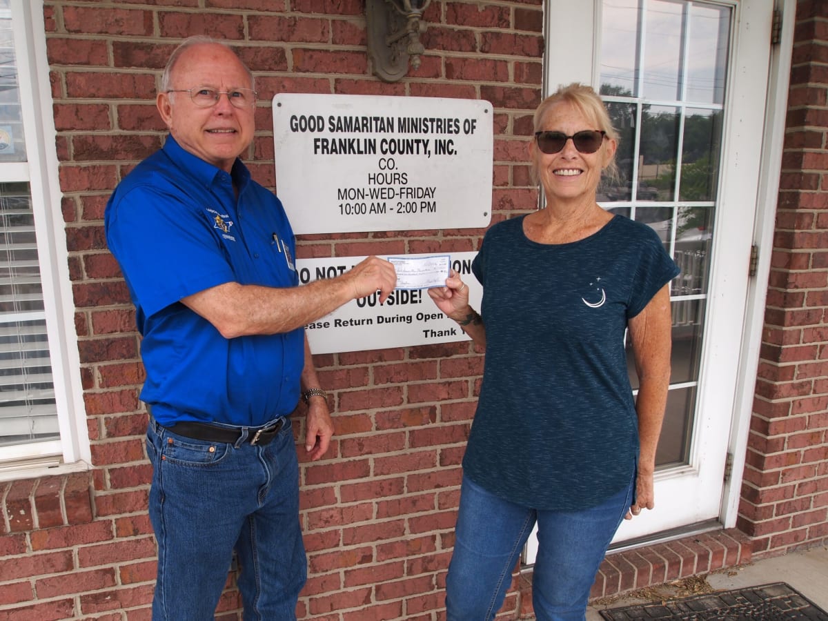 Grand Knight David Ryan presenting large ceremonial check to Good Samaritan Ministries volunteer in Tennessee
