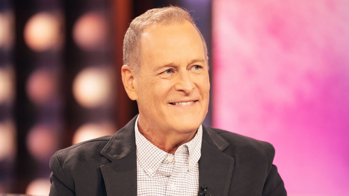 Dave Coulier smiling during television interview after completing cancer treatment