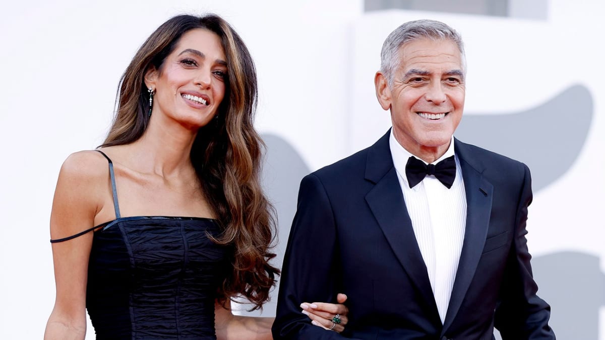 George Clooney holds Golden Lion award alongside Laura Dern at Venice Film Festival opening ceremony