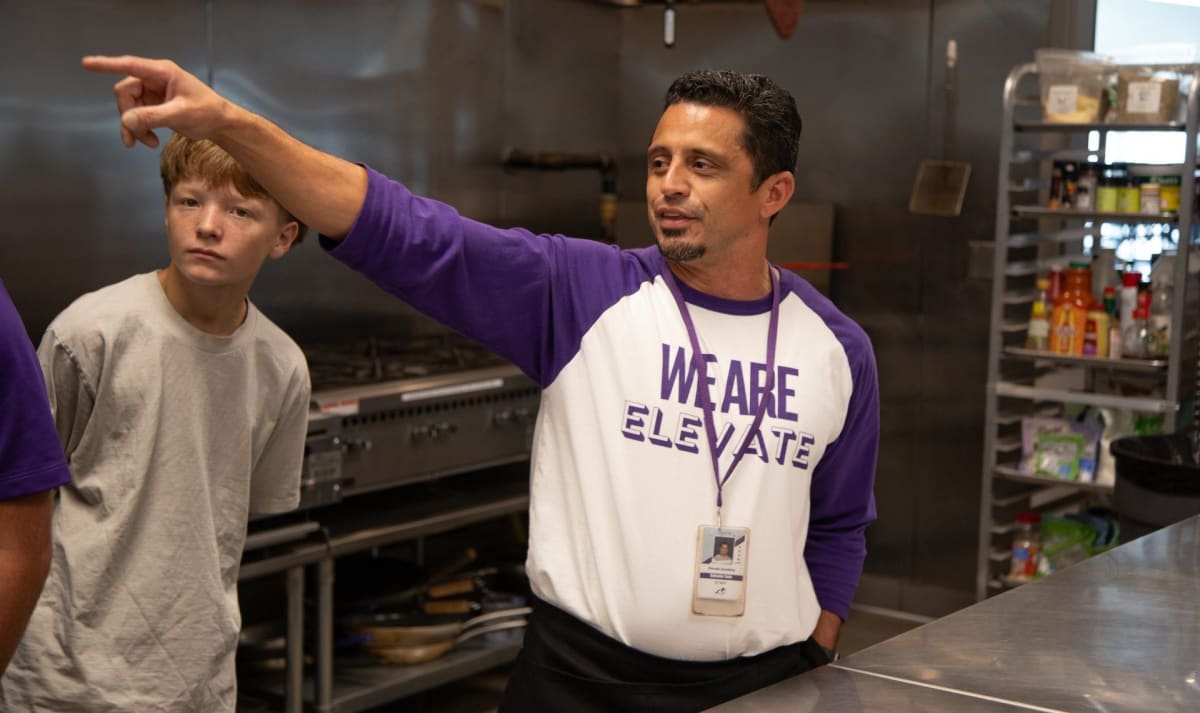 Culinary teacher Sal Soto instructing students in commercial kitchen at Idaho charter school