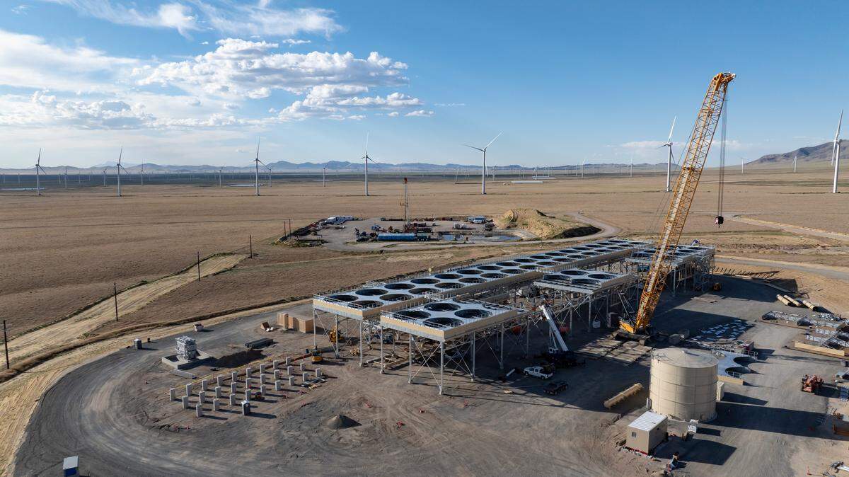 Steam rising from geothermal power plant with Idaho mountains in background