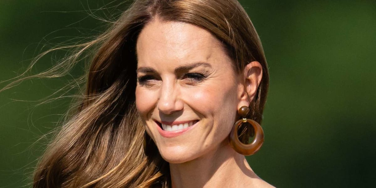 Kate Middleton in black and white gingham dress helping steady trophy at charity polo match
