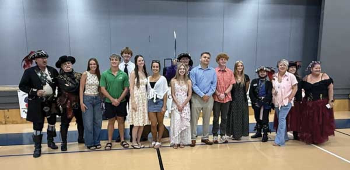 Fourteen scholarship recipients pose with Anna Maria Island Privateers members at awards ceremony
