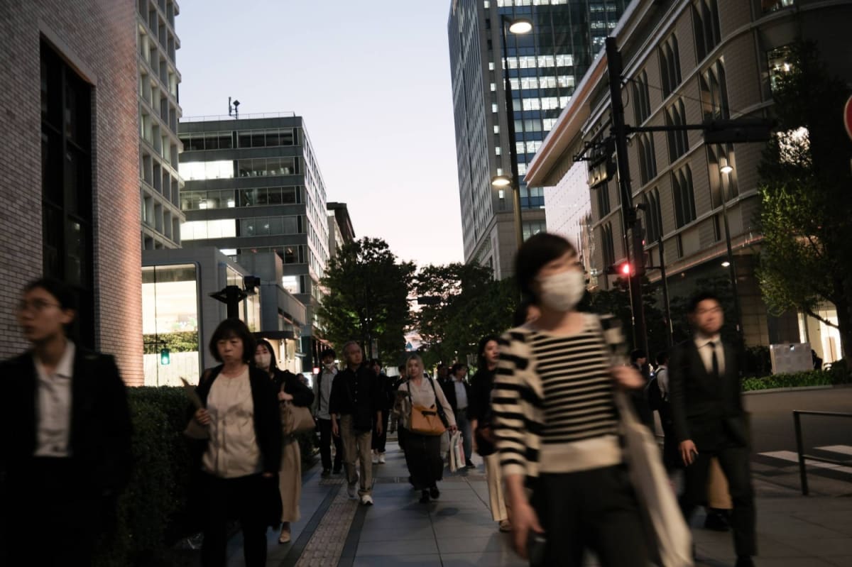 Professional Japanese office workers collaborating respectfully in modern workplace setting