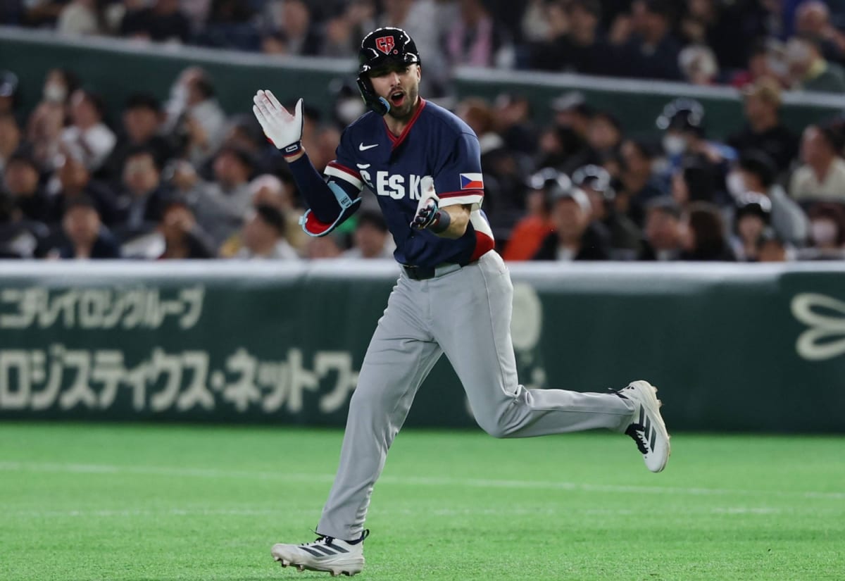 Japanese baseball fans wearing Czech Republic jerseys and holding support signs at World Baseball Classic game