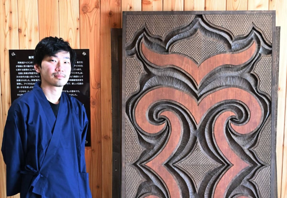 Students learning traditional Ainu woodcarving at craft center in Hokkaido, Japan