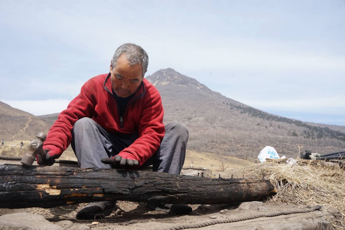 Elderly Japanese man smiling, representing lifelong learner and disaster relief volunteer Haruo Obata
