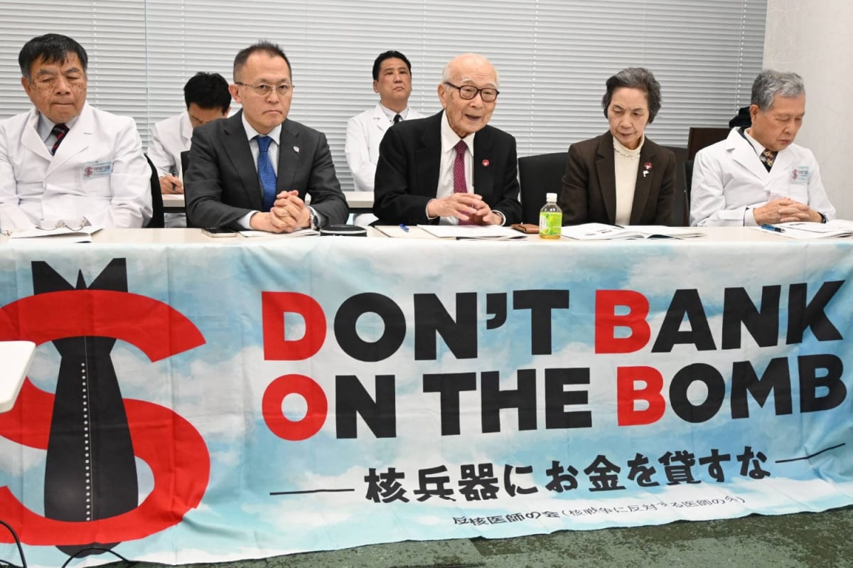 Japanese atomic bomb survivors meeting with financial institution officials in Tokyo conference room
