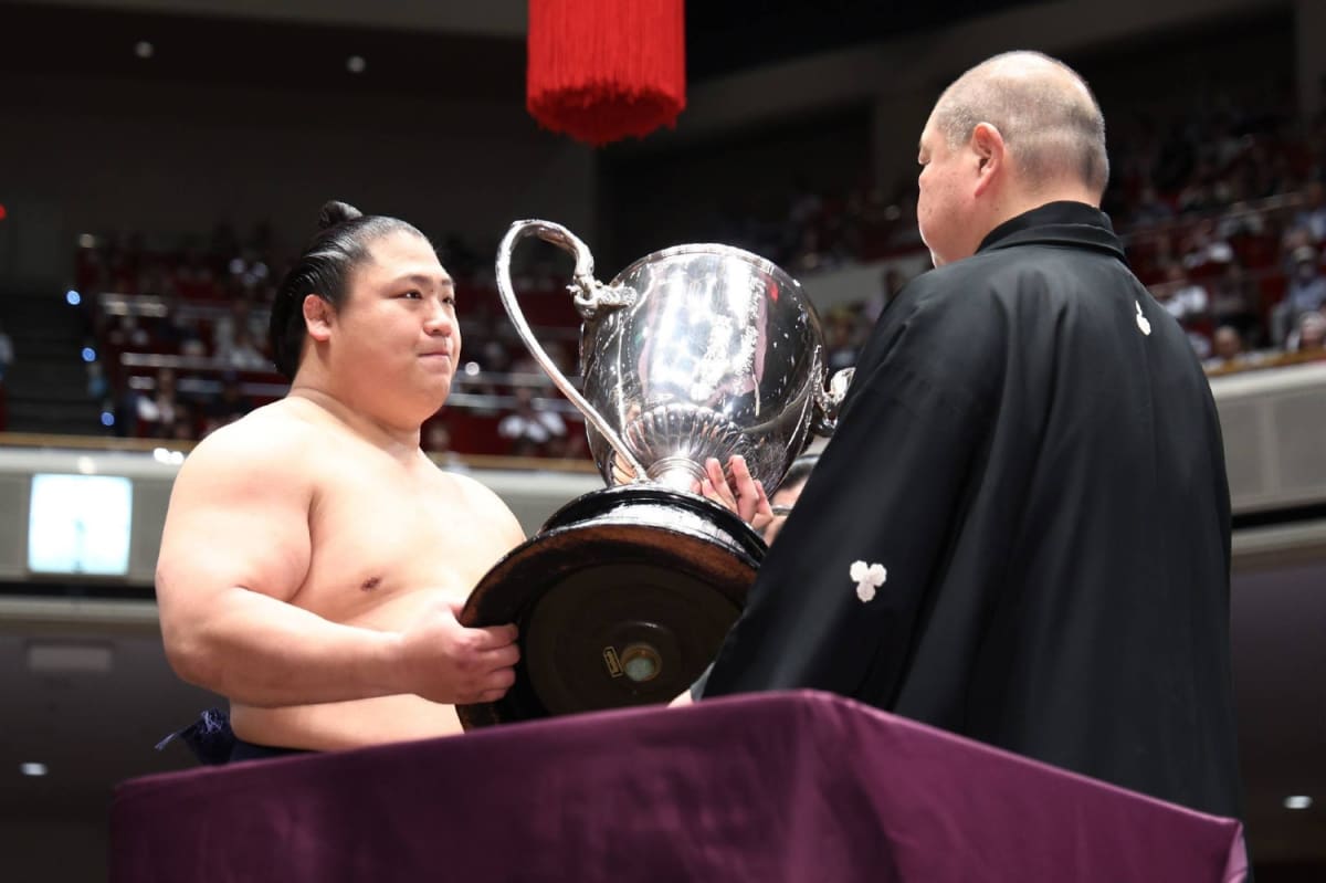 Japanese sumo wrestler Wakatakakage celebrates winning the prestigious Emperor's Cup at tournament