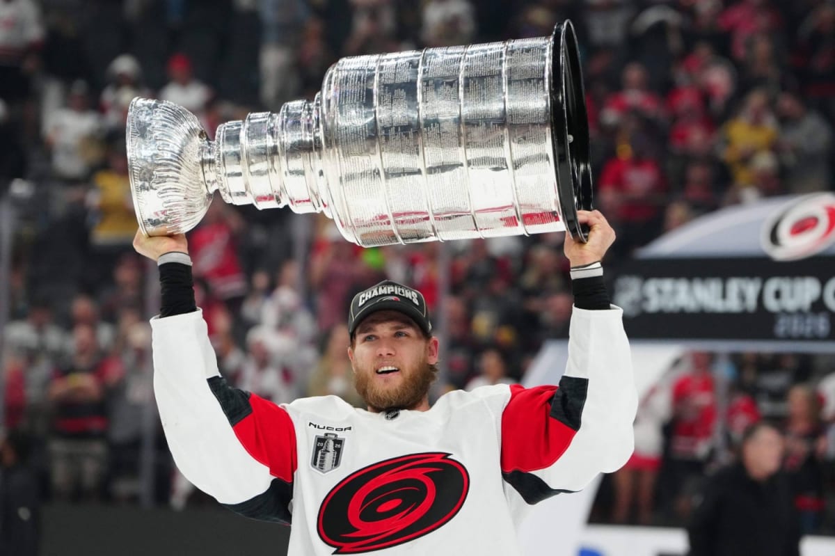 Carolina Hurricanes head coach Rod Brind'Amour celebrating with Stanley Cup trophy on ice