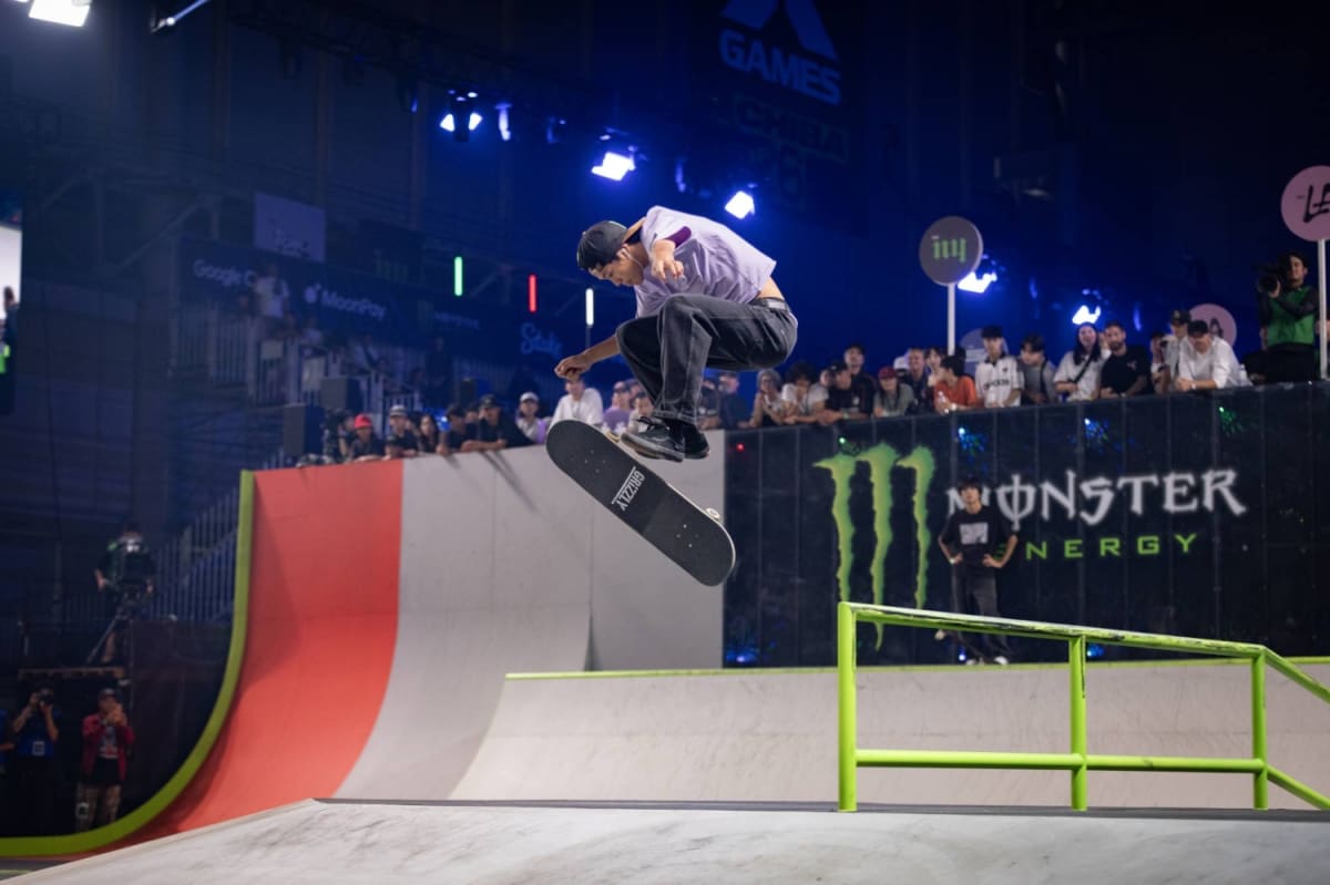 Japanese skateboarder performing aerial trick at X Games Chiba competition venue