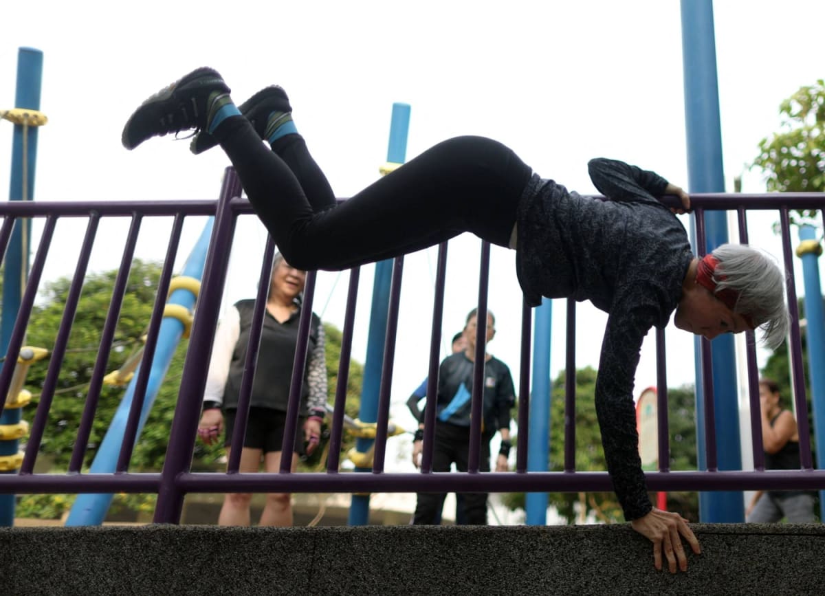 Senior woman practicing parkour movements in Singapore fitness class for elderly adults