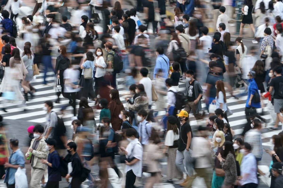 Japanese healthcare workers reviewing positive public health data showing declining HIV infection rates over time