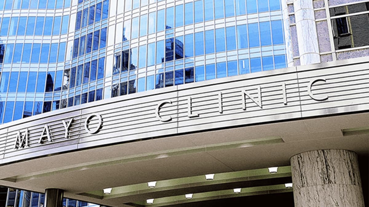 Medical professionals at Mayo Clinic preparing electromagnetic hyperthermia equipment for cancer treatment trials