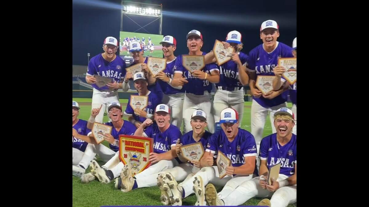 Team Kansas high school baseball players celebrate in purple jerseys after winning national championship