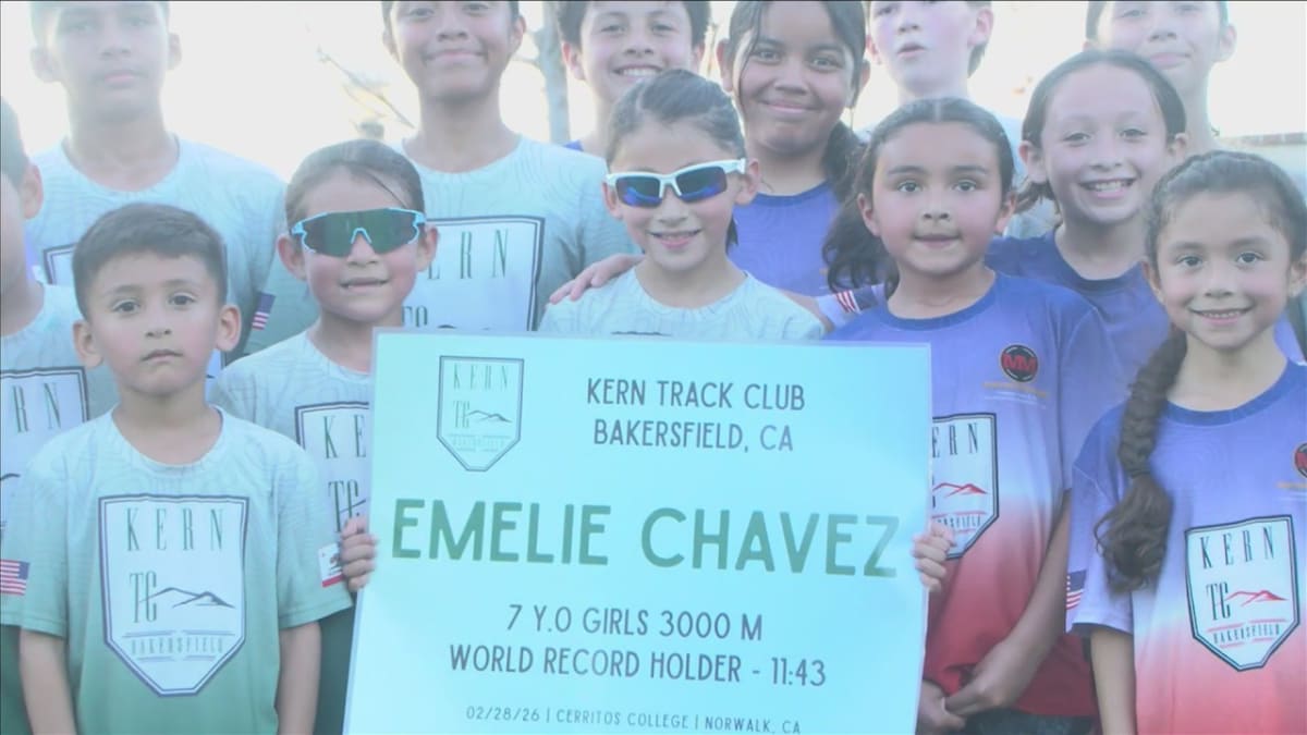 Seven-year-old Emelie Chavez running at track practice wearing American flag shorts and sunglasses