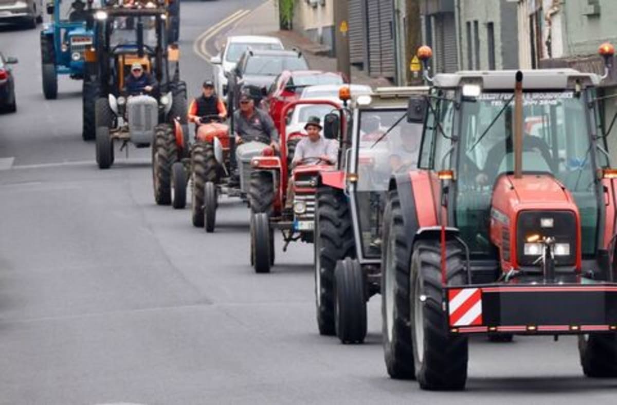 Vintage tractors and classic vehicles parade through Kilcullen Ireland for annual cancer charity rally