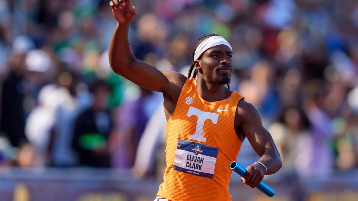 Four Tennessee track athletes celebrating with arms raised after winning NCAA relay championship