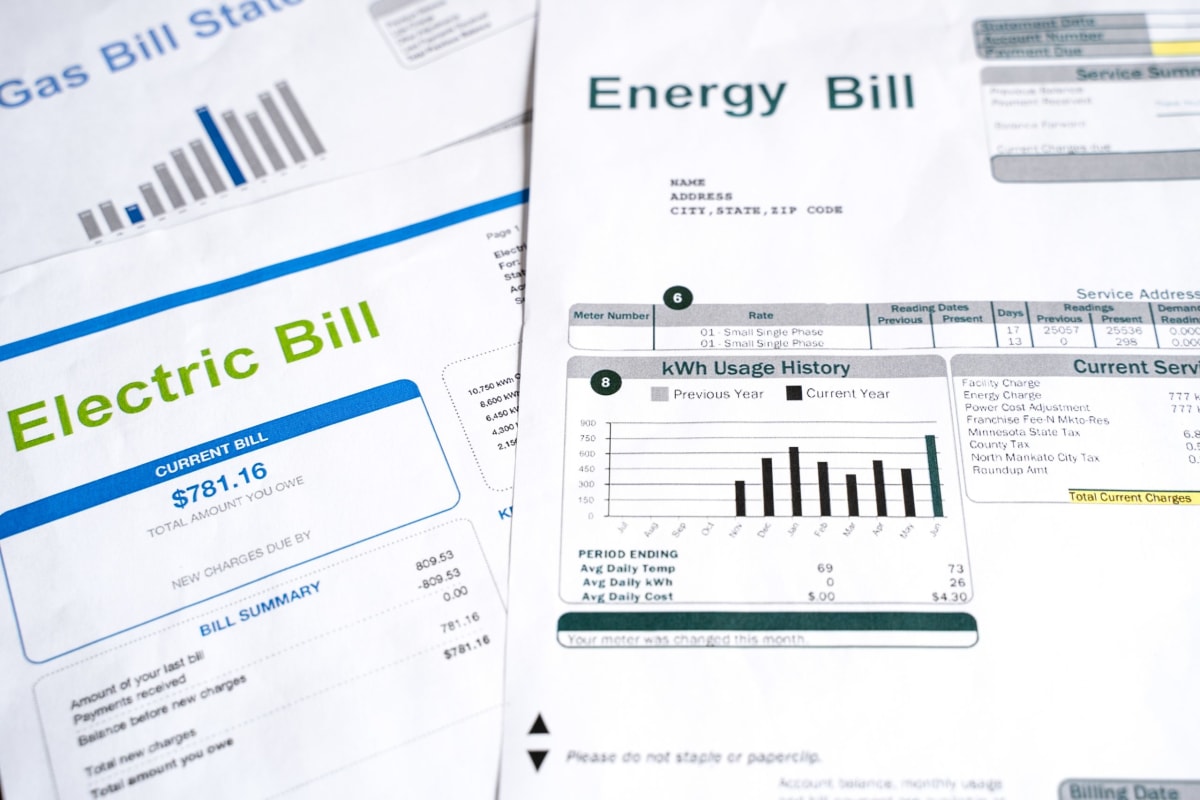 Diverse group of advocates reviewing energy policy documents and utility bills together