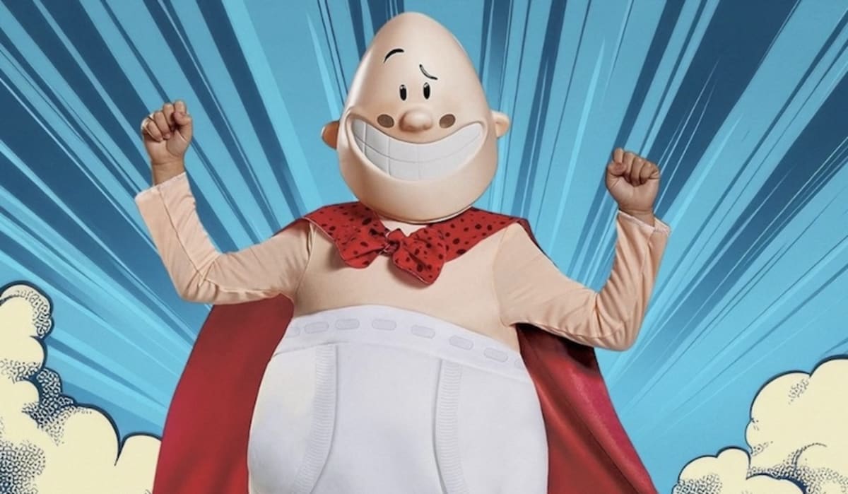 Runner in Captain Underpants costume with cape and headband training for marathon world record