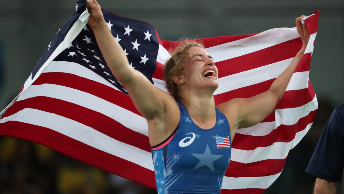 Helen Maroulis celebrating with gold medal raised above her head at Olympic Games