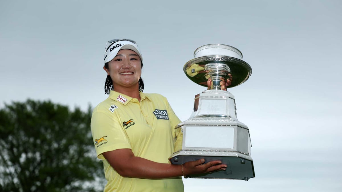Haeran Ryu holding championship trophy on 18th green at Hazeltine National Golf Club