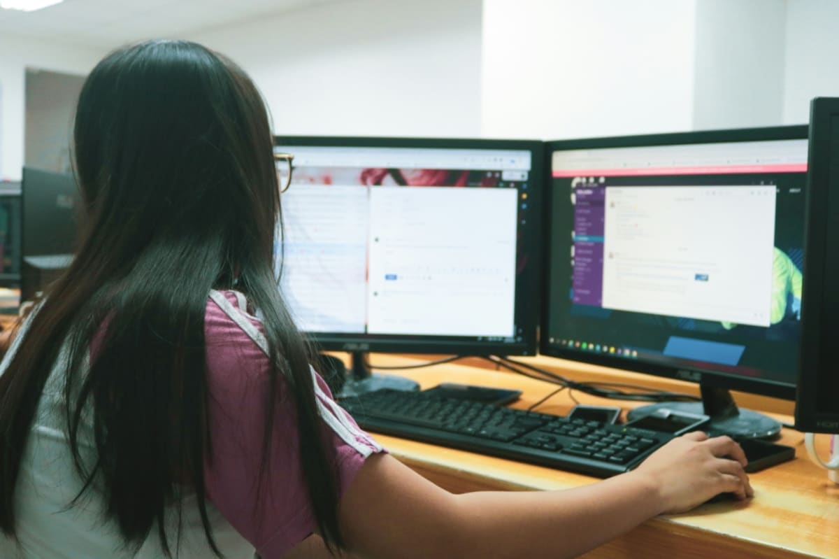 Students studying together at Nanyang Technological University campus in Singapore with laptops and books