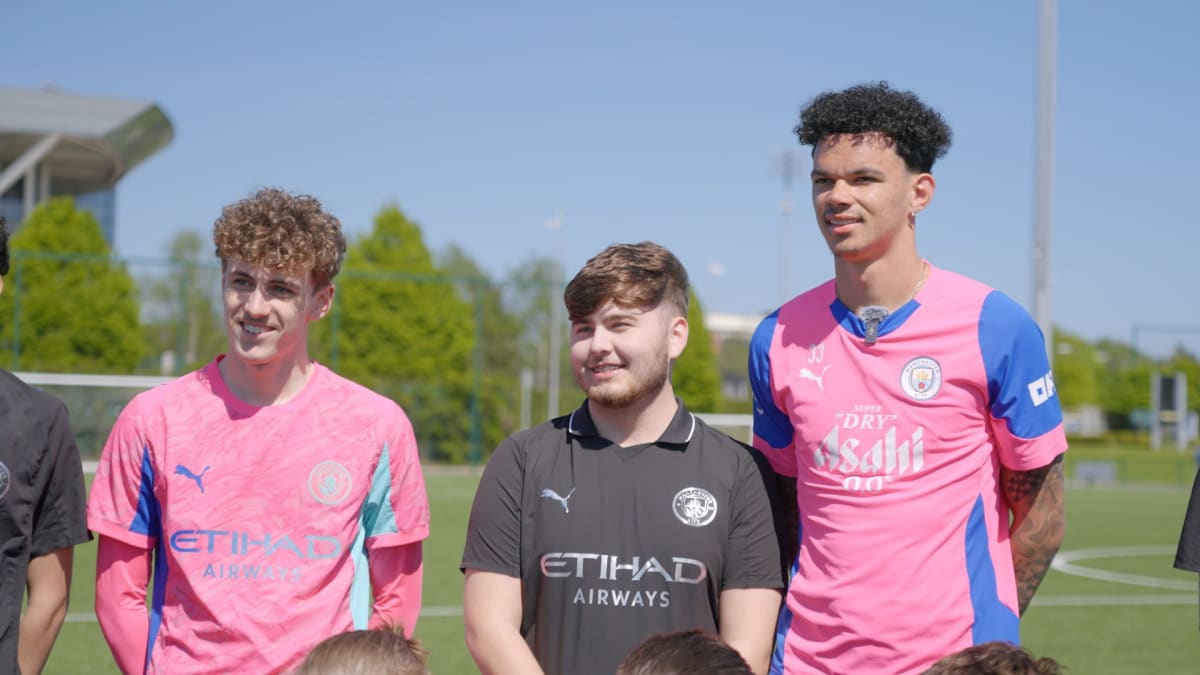 Manchester City football players in blue uniforms supporting youth mentoring charity program