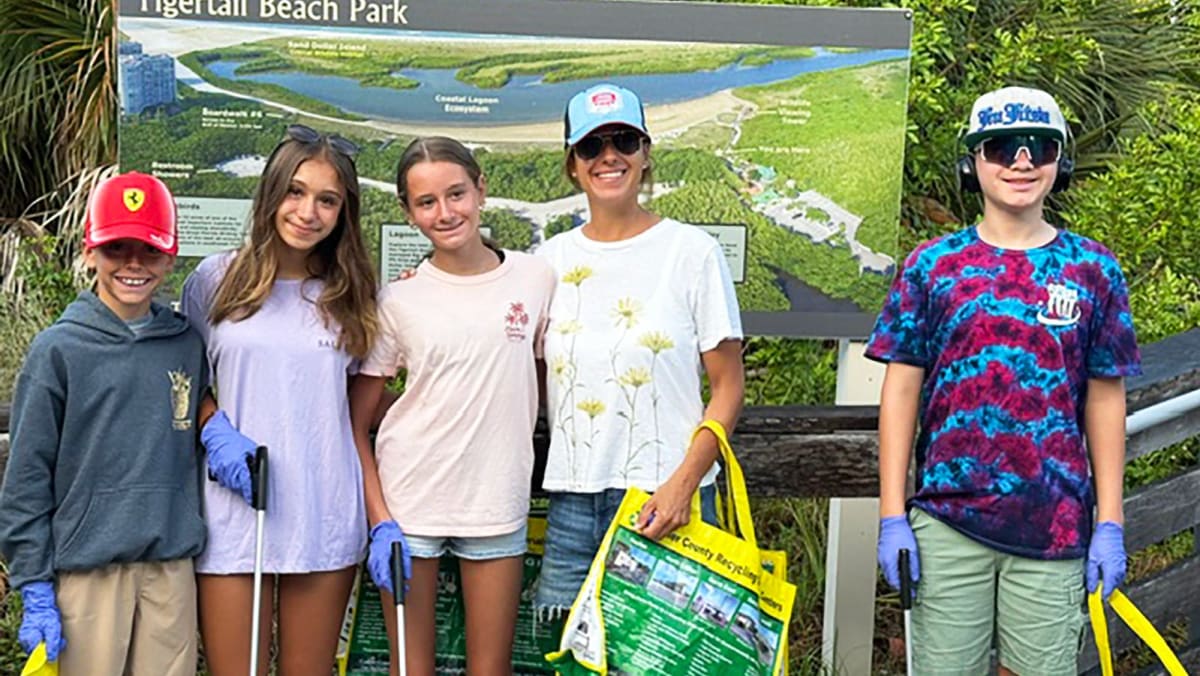 Volunteers collecting trash and recyclables during beach cleanup at Tigertail Beach in Marco Island, Florida