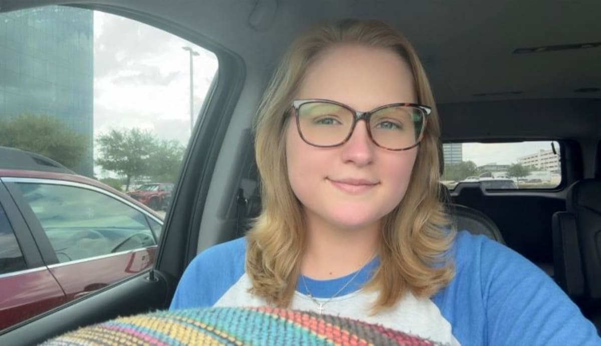 Young woman smiling confidently after overcoming rare ovarian cancer with specialized treatment team