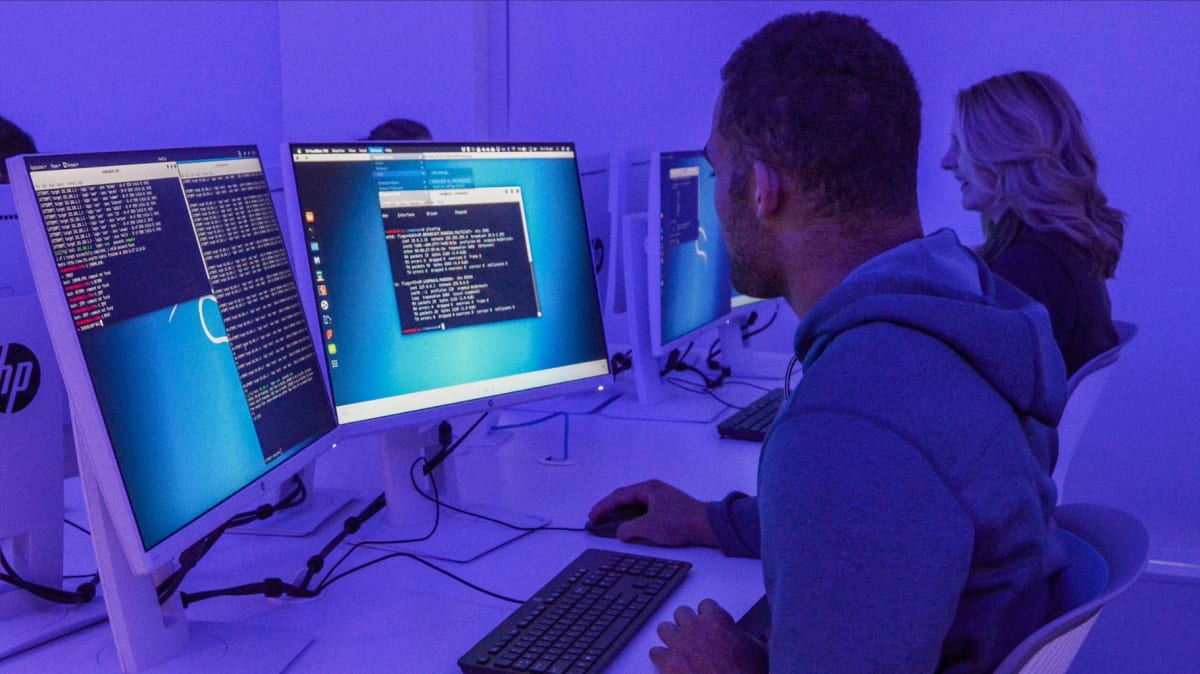 Mercyhurst University students working together on computers in cybersecurity and data science classroom