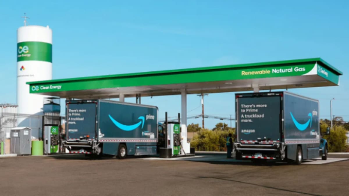 Semi-truck refueling at renewable natural gas station along major freight corridor
