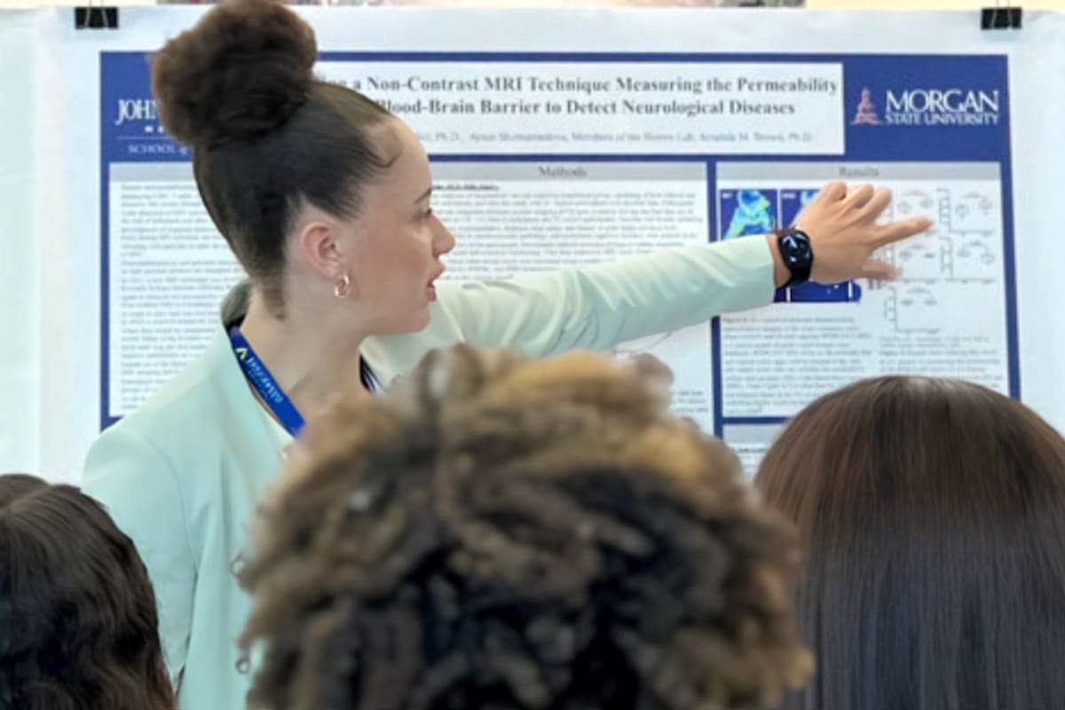 ** Tyrah Weems conducting biomedical research in laboratory wearing safety equipment at Morgan State University