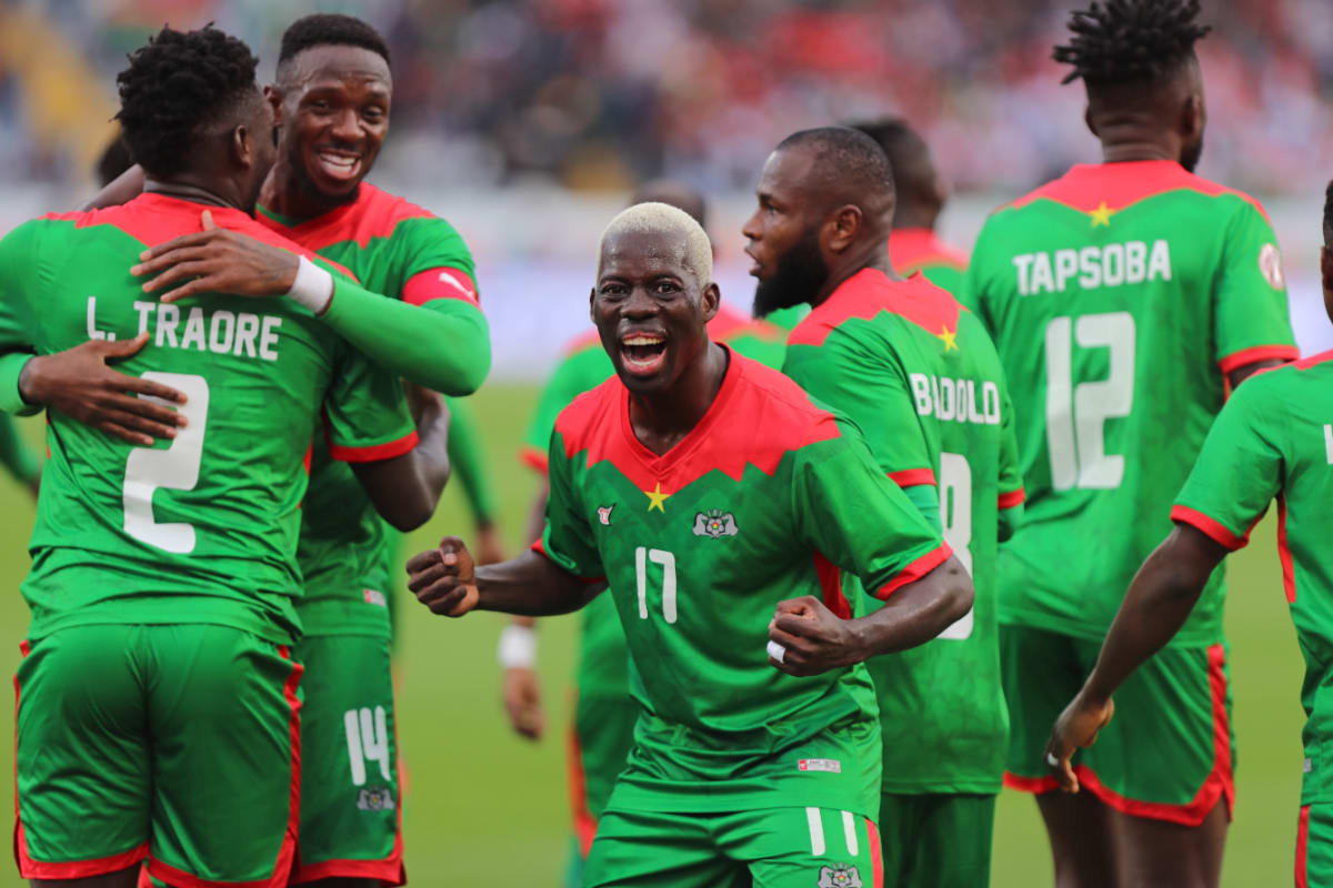 Burkina Faso national soccer team celebrating on field after 5-0 victory against Guinea-Bissau