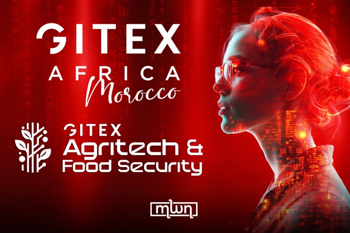 African farmer using smartphone in field with crops, representing digital agricultural innovation